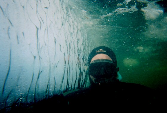 René underwater next to block of ice